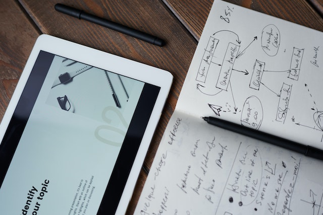 an iPad on the table, with a sheet containing notes on inbound marketing